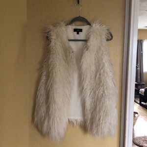Faux furry cream vest with hooks to close.  Lined.